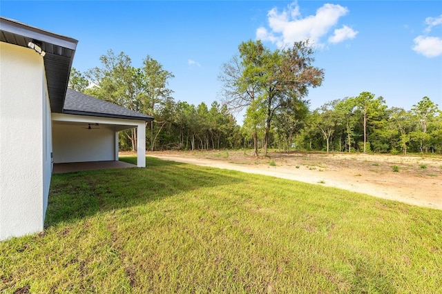 8200 SW 125th Court Rd, Dunnellon, FL 34432 - view of green lawn with a ceiling fan and a forest view