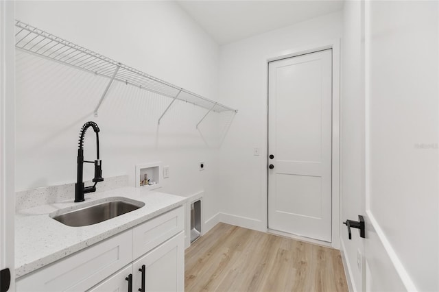 8200 SW 125th Court Rd, Dunnellon, FL 34432 - washroom featuring cabinet space, light wood finished floors, hookup for an electric dryer, hookup for a washing machine, and baseboards
