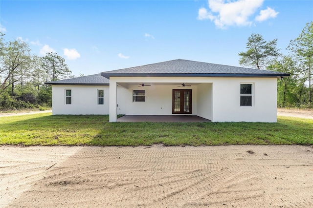 8200 SW 125th Court Rd, Dunnellon, FL 34432 - rear view of house with french doors, a ceiling fan, stucco siding, and a yard