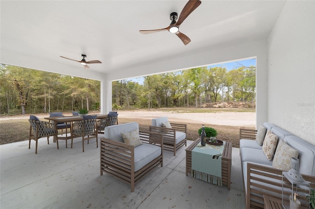 8200 SW 125th Court Rd, Dunnellon, FL 34432 - view of patio with a ceiling fan, an outdoor hangout area, outdoor dining area, and view of wooded area