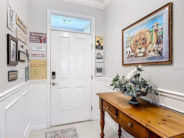 9237 SW 60th Terrace Rd, Ocala, FL 34476 - entryway with light tile patterned floors, a wainscoted wall, ornamental molding, and a decorative wall