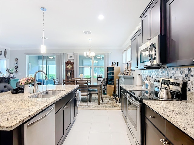 9237 SW 60th Terrace Rd, Ocala, FL 34476 - kitchen featuring stainless steel appliances, a sink, ornamental molding, a chandelier, and backsplash