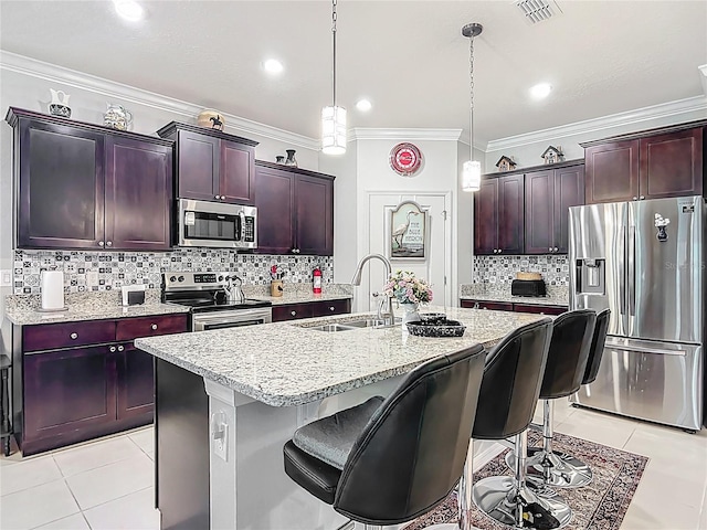 9237 SW 60th Terrace Rd, Ocala, FL 34476 - kitchen featuring stainless steel appliances, a sink, crown molding, light tile patterned floors, and a kitchen breakfast bar