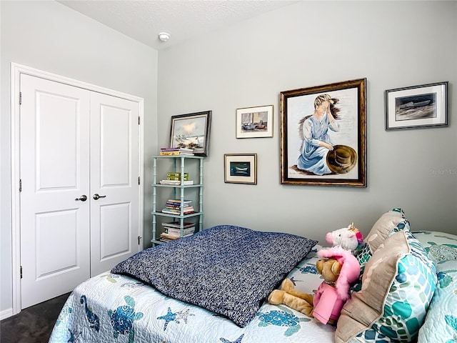 9237 SW 60th Terrace Rd, Ocala, FL 34476 - bedroom with dark carpet, a closet, and a textured ceiling