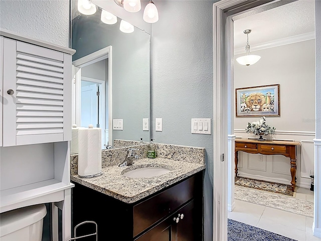 9237 SW 60th Terrace Rd, Ocala, FL 34476 - bathroom with vanity, ornamental molding, toilet, a textured wall, and tile patterned flooring