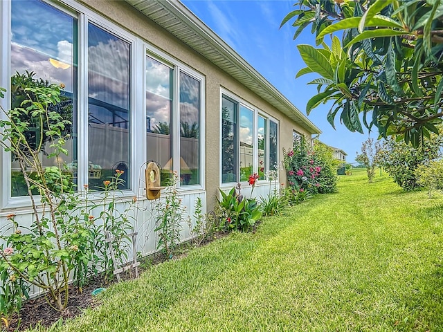 9237 SW 60th Terrace Rd, Ocala, FL 34476 - view of home's exterior with a lawn and stucco siding