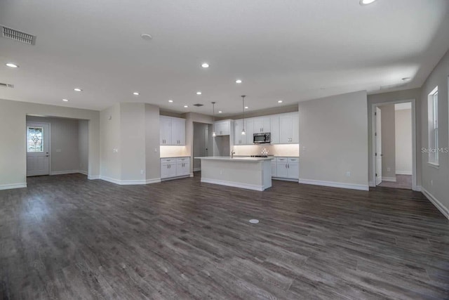 5830 SW 121st Ter, Ocala, FL 34481 - unfurnished living room featuring baseboards, dark wood-type flooring, and recessed lighting
