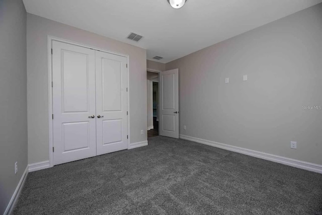 5830 SW 121st Ter, Ocala, FL 34481 - unfurnished bedroom featuring dark colored carpet, a closet, and baseboards
