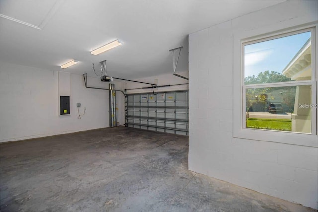 5830 SW 121st Ter, Ocala, FL 34481 - garage with electric panel, a garage door opener, and concrete block wall