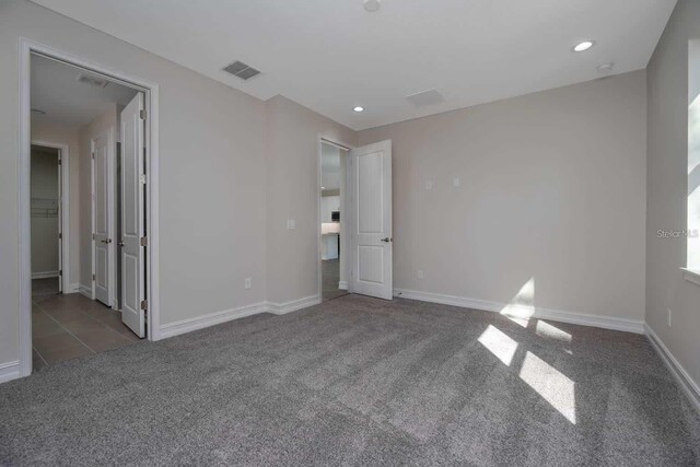 5830 SW 121st Ter, Ocala, FL 34481 - unfurnished bedroom with carpet floors, baseboards, and recessed lighting