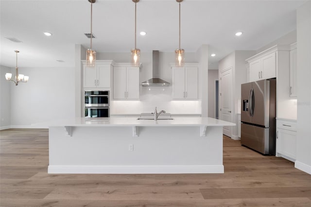 2050 NW 79th Loop, Ocala, FL 34475 - kitchen with appliances with stainless steel finishes, wall chimney exhaust hood, light countertops, a sink, and recessed lighting