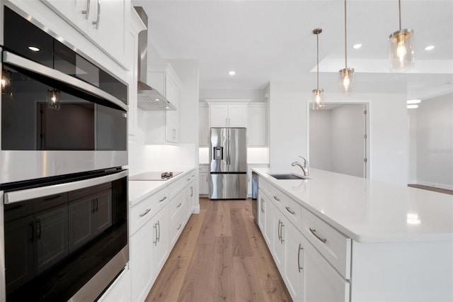 2050 NW 79th Loop, Ocala, FL 34475 - kitchen featuring stainless steel appliances, a sink, wall chimney range hood, light wood-style flooring, and light countertops