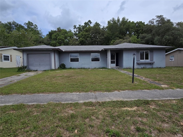 9330 N Citrus Springs Blvd, Citrus Springs, FL 34434 - ranch-style house with an attached garage, concrete driveway, a front lawn, and stucco siding