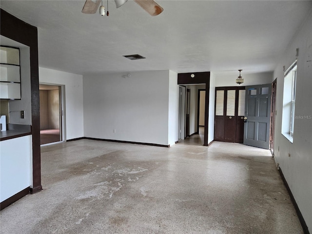 9330 N Citrus Springs Blvd, Citrus Springs, FL 34434 - unfurnished living room with baseboards, a ceiling fan, and speckled floor