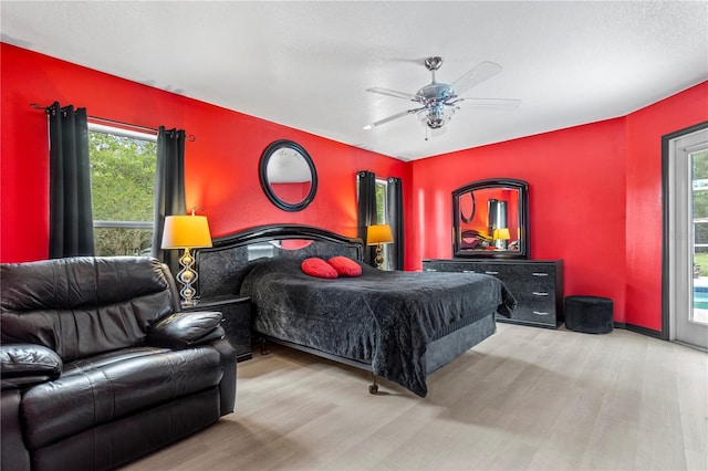 2698 SW 186th Ct, Dunnellon, FL 34432 - bedroom with wood finished floors, multiple windows, and a ceiling fan
