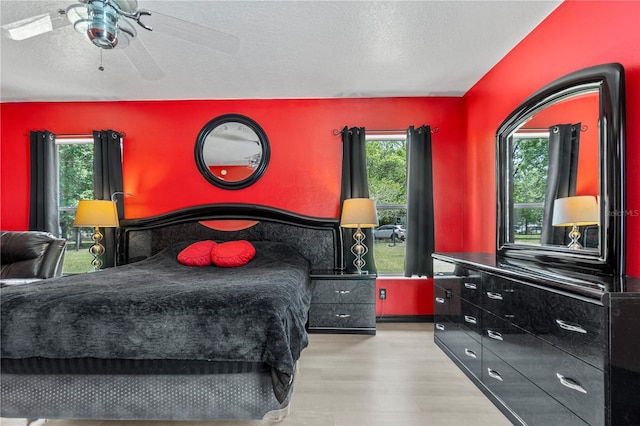 2698 SW 186th Ct, Dunnellon, FL 34432 - bedroom with wood finished floors, a textured ceiling, and a ceiling fan