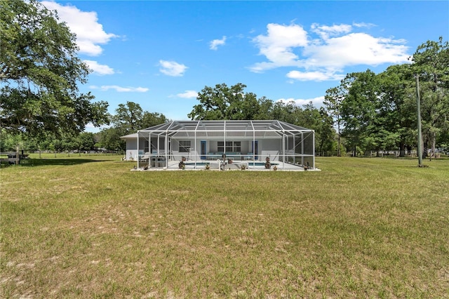 2698 SW 186th Ct, Dunnellon, FL 34432 - back of property with a lawn, an outdoor pool, a patio area, and glass enclosure