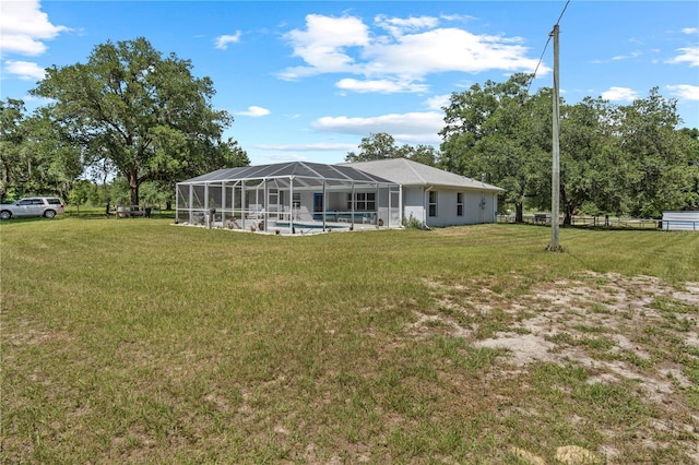2698 SW 186th Ct, Dunnellon, FL 34432 - rear view of house with an outdoor pool, a lawn, and glass enclosure