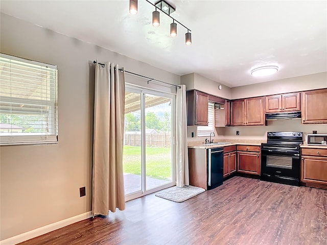 1520 NE 17th Ave, Ocala, FL 34470 - kitchen with black / electric stove, a sink, dishwasher, light countertops, and under cabinet range hood