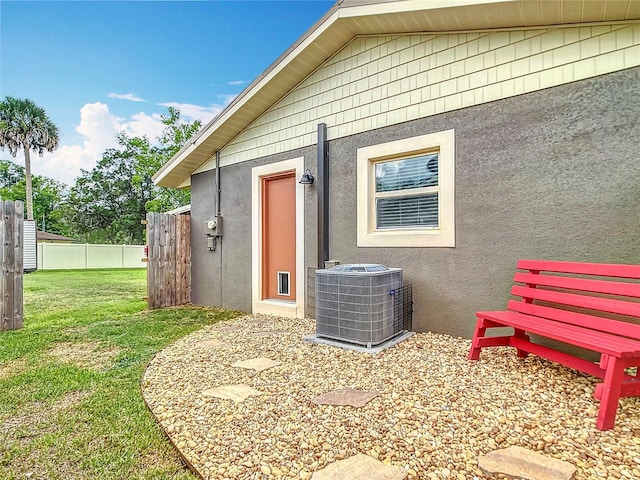 1520 NE 17th Ave, Ocala, FL 34470 - view of exterior entry with central air condition unit and stucco siding