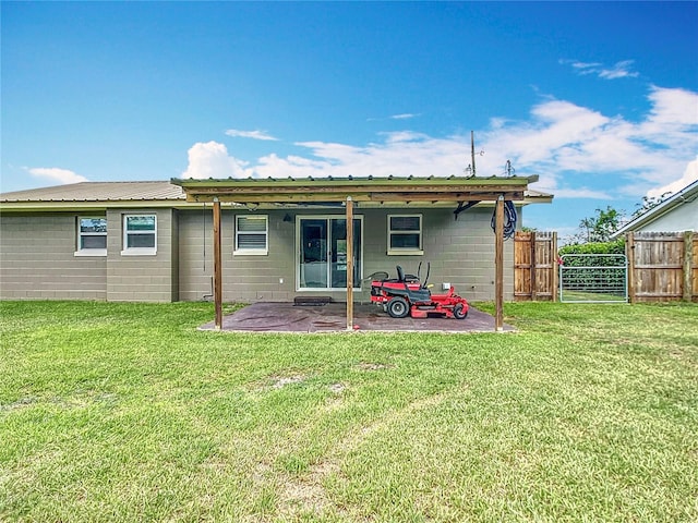 1520 NE 17th Ave, Ocala, FL 34470 - back of house with concrete block siding and a patio area