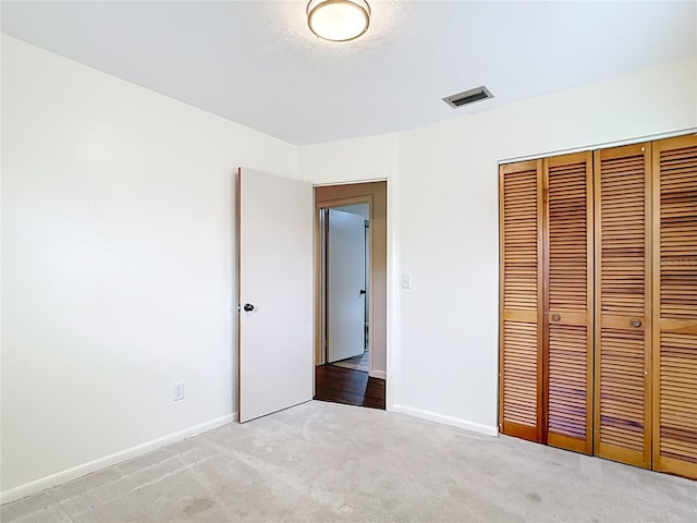 1520 NE 17th Ave, Ocala, FL 34470 - unfurnished bedroom with light colored carpet, a closet, and baseboards