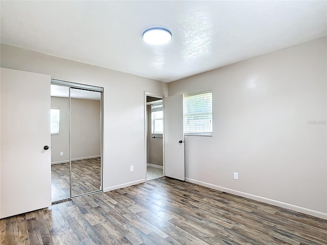 1520 NE 17th Ave, Ocala, FL 34470 - unfurnished bedroom with wood finished floors, baseboards, and a closet