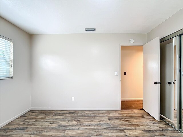 1520 NE 17th Ave, Ocala, FL 34470 - empty room with wood finished floors, baseboards, and a smoke detector