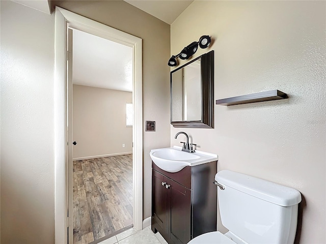 1520 NE 17th Ave, Ocala, FL 34470 - bathroom with vanity, toilet, baseboards, and wood finished floors