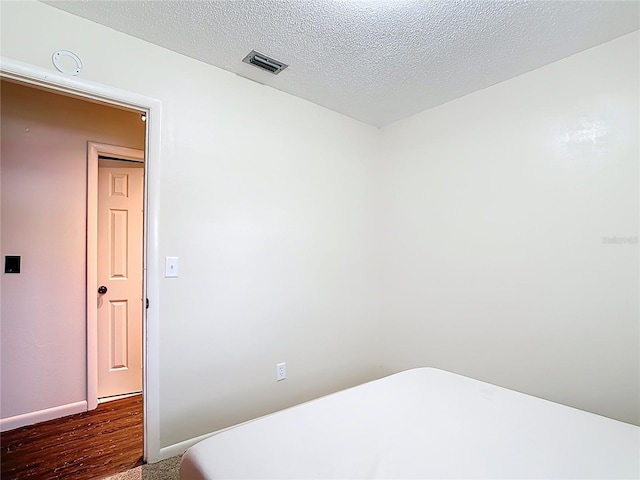 1520 NE 17th Ave, Ocala, FL 34470 - unfurnished room featuring wood finished floors, baseboards, and a textured ceiling