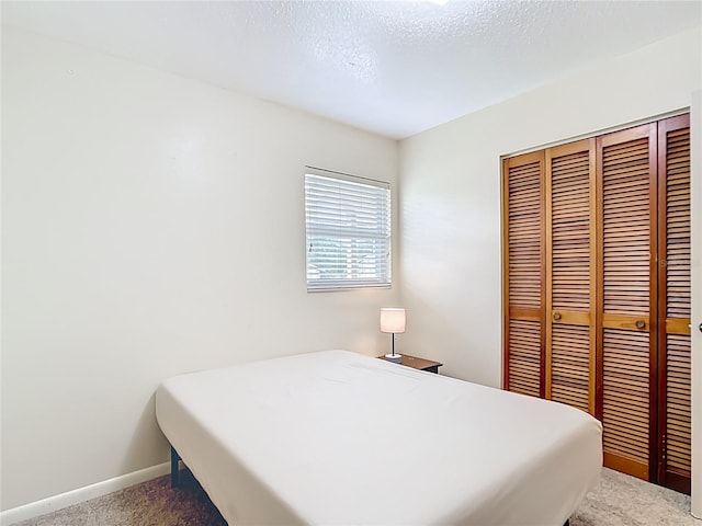1520 NE 17th Ave, Ocala, FL 34470 - bedroom featuring light colored carpet, a closet, and baseboards