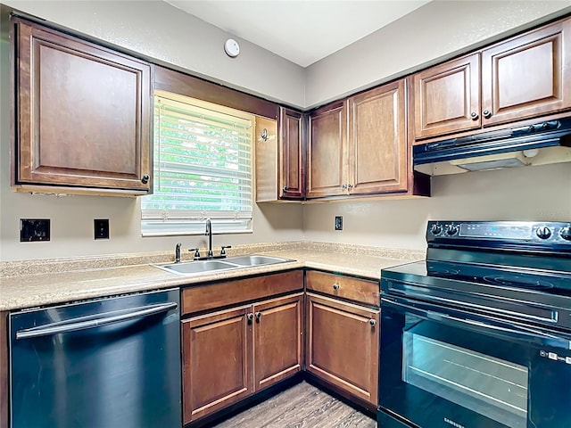 1520 NE 17th Ave, Ocala, FL 34470 - kitchen with electric range, dishwasher, under cabinet range hood, a sink, and light countertops