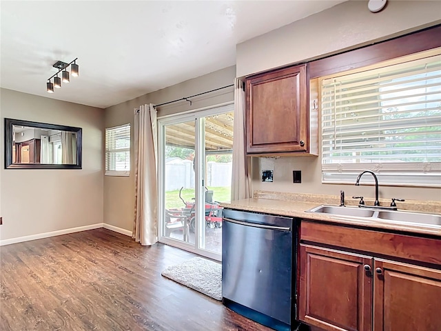 1520 NE 17th Ave, Ocala, FL 34470 - kitchen with dishwasher, a sink, dark wood-type flooring, light countertops, and rail lighting