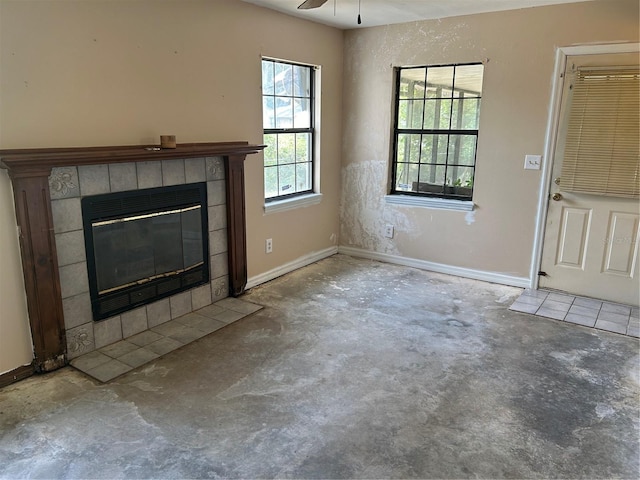 3885 NE 28th Ter, Ocala, FL 34479 - unfurnished living room featuring unfinished concrete floors, a fireplace, and baseboards