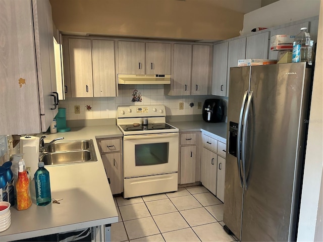 3885 NE 28th Ter, Ocala, FL 34479 - kitchen with stainless steel fridge with ice dispenser, white electric range oven, under cabinet range hood, a sink, and light tile patterned floors