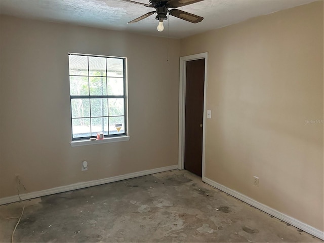 3885 NE 28th Ter, Ocala, FL 34479 - spare room with ceiling fan, baseboards, and concrete flooring