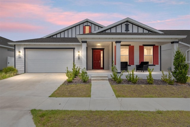 6486 SW 75th Avenue Rd, Ocala, FL 34474 - view of front of home with a porch, board and batten siding, a garage, and concrete driveway