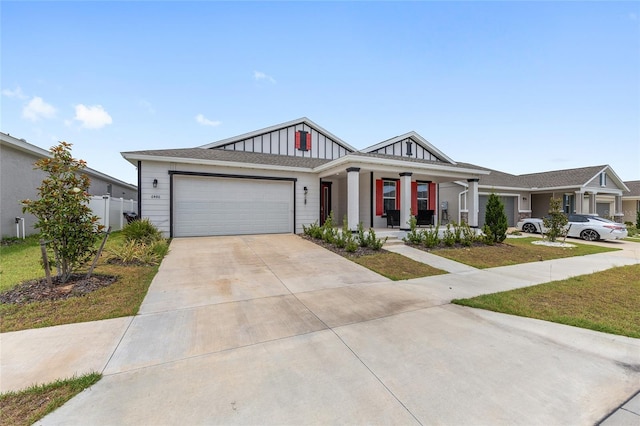 6486 SW 75th Avenue Rd, Ocala, FL 34474 - view of front of property with board and batten siding, covered porch, an attached garage, concrete driveway, and a front lawn