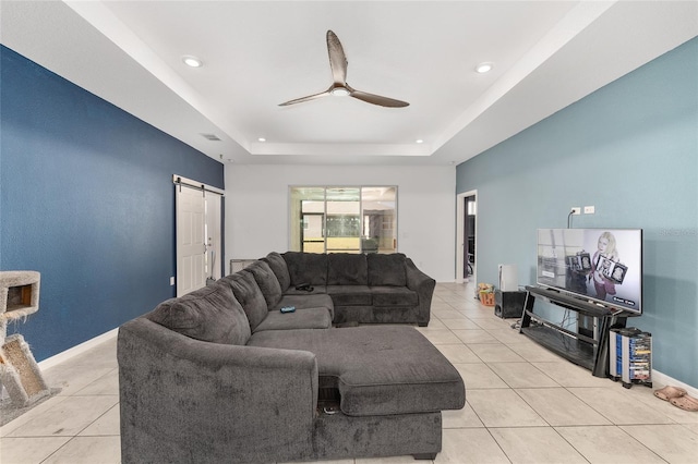 6486 SW 75th Avenue Rd, Ocala, FL 34474 - living room featuring light tile patterned floors, a ceiling fan, a barn door, a raised ceiling, and recessed lighting