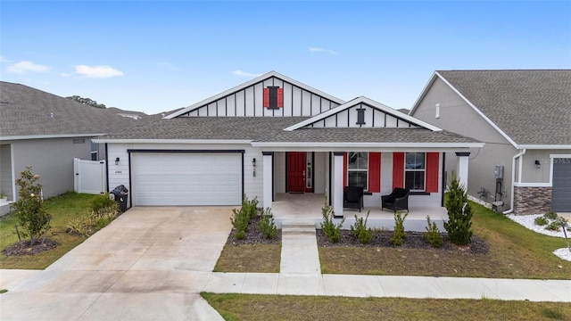 6486 SW 75th Avenue Rd, Ocala, FL 34474 - view of front facade with a porch, an attached garage, concrete driveway, and board and batten siding