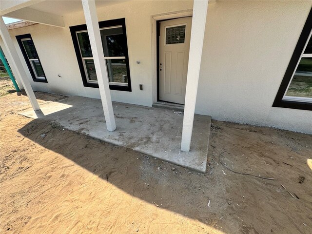 5709 NW 6th Pl, Ocala, FL 34482 - view of exterior entry featuring stucco siding
