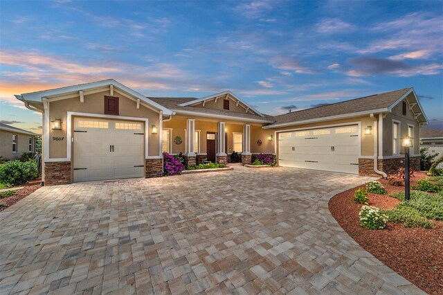 9607 SW 79th Lane Rd, Ocala, FL 34481 - craftsman inspired home with an attached garage, stone siding, stucco siding, and decorative driveway