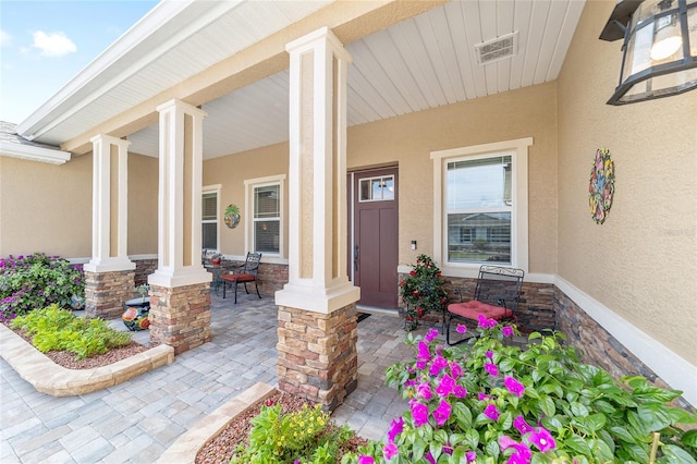 9607 SW 79th Lane Rd, Ocala, FL 34481 - view of exterior entry with a porch and stucco siding