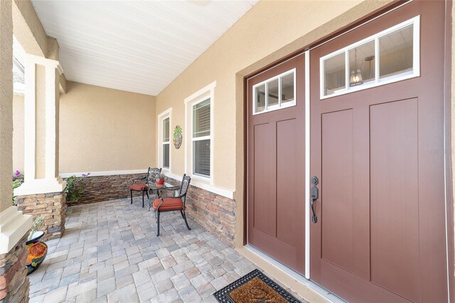 9607 SW 79th Lane Rd, Ocala, FL 34481 - view of exterior entry with covered porch and stucco siding