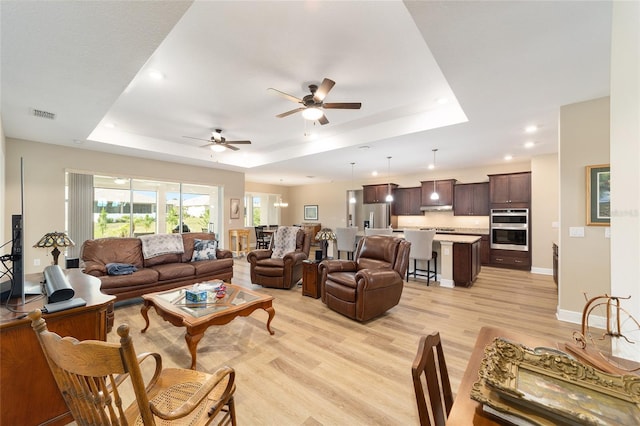 9607 SW 79th Lane Rd, Ocala, FL 34481 - living area with a raised ceiling, light wood finished floors, ceiling fan, recessed lighting, and baseboards