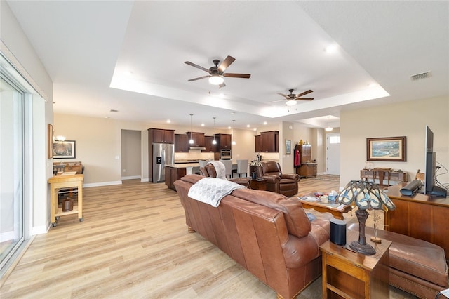 9607 SW 79th Lane Rd, Ocala, FL 34481 - living area featuring a tray ceiling, ceiling fan, light wood-style flooring, recessed lighting, and baseboards