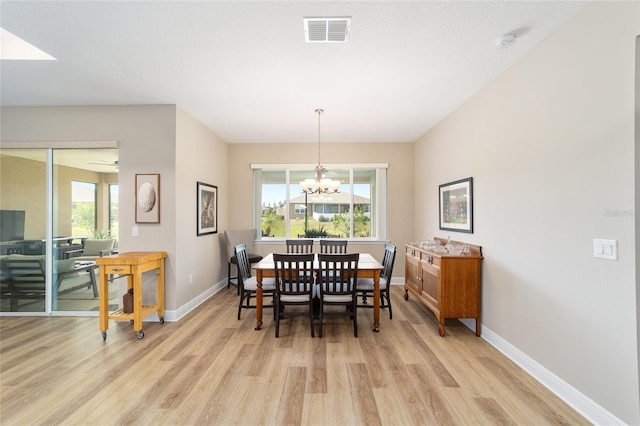 9607 SW 79th Lane Rd, Ocala, FL 34481 - dining space with light wood-type flooring, baseboards, a chandelier, and healthy amount of natural light