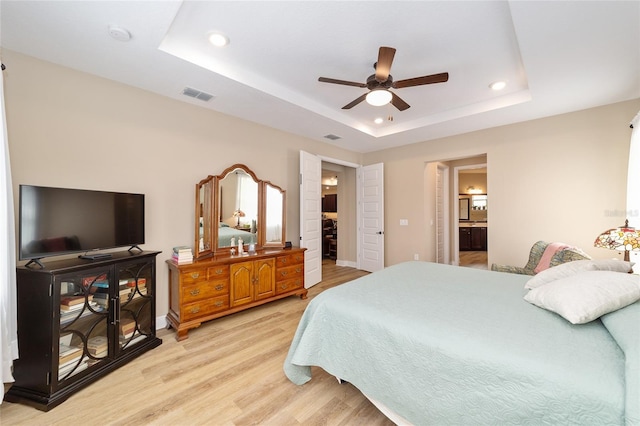 9607 SW 79th Lane Rd, Ocala, FL 34481 - bedroom featuring recessed lighting, a tray ceiling, light wood finished floors, baseboards, and ensuite bathroom
