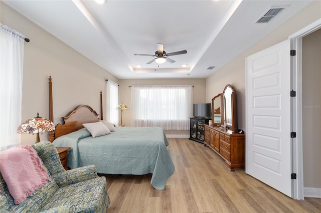 9607 SW 79th Lane Rd, Ocala, FL 34481 - bedroom with a raised ceiling, light wood finished floors, and a ceiling fan