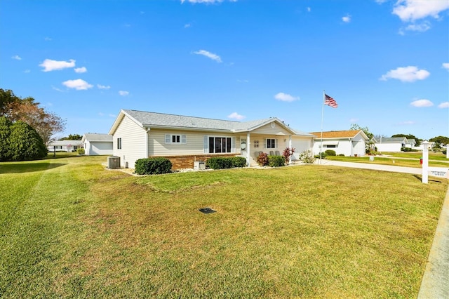 17890 SE 96th Ct, Summerfield, FL 34491 - ranch-style home with cooling unit, concrete driveway, an attached garage, and a front lawn